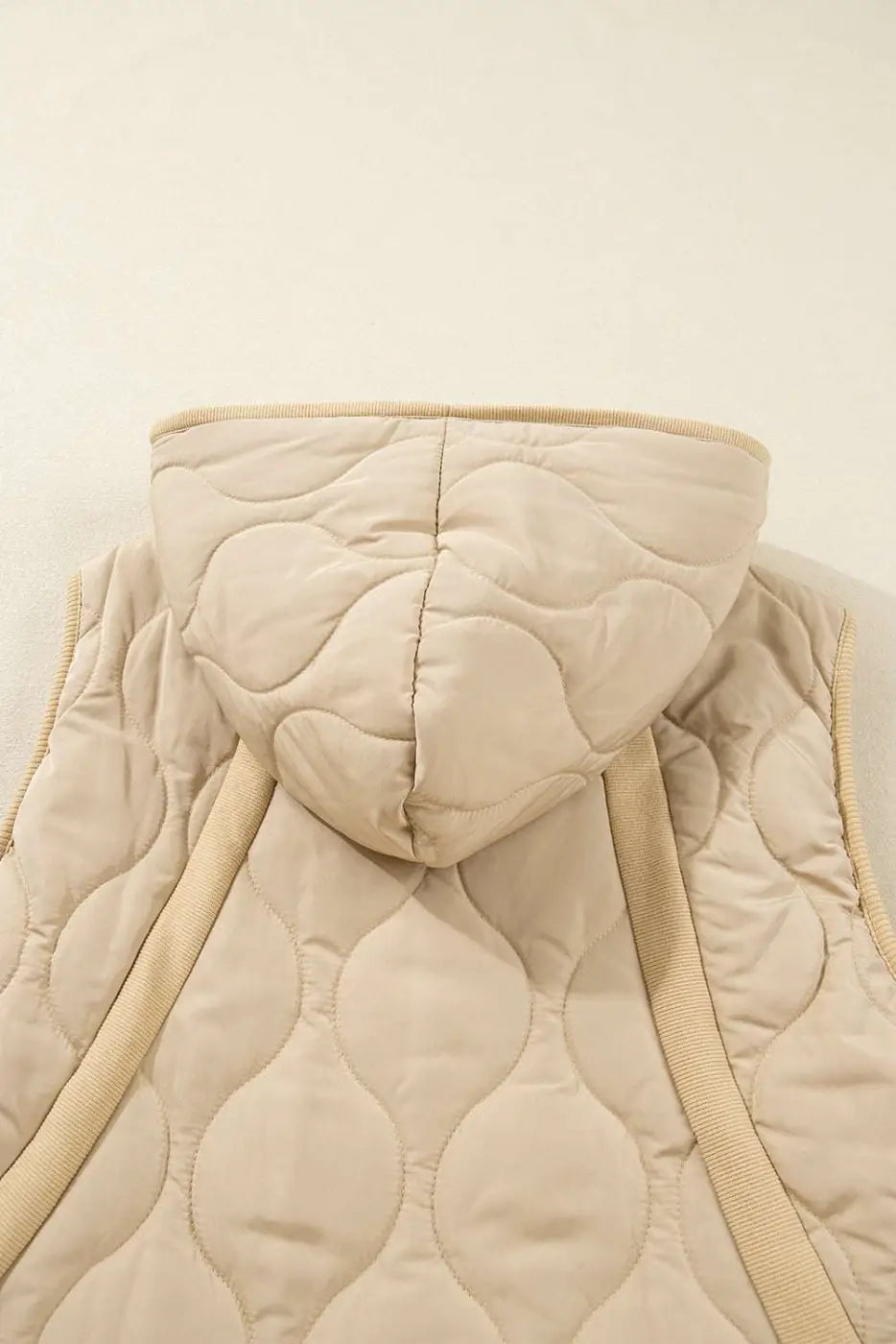 Back detail of khaki Quilted Fleece‑Lined Winter Gilet highlighting hood, quilted texture, and ribbed trim accents.