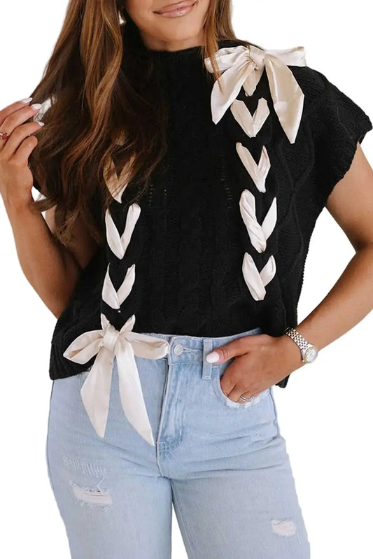 Satin Bowknot Sweater - Short Sleeve Style in black knit with cream satin bows, styled casually with ripped jeans for a chic fall look.