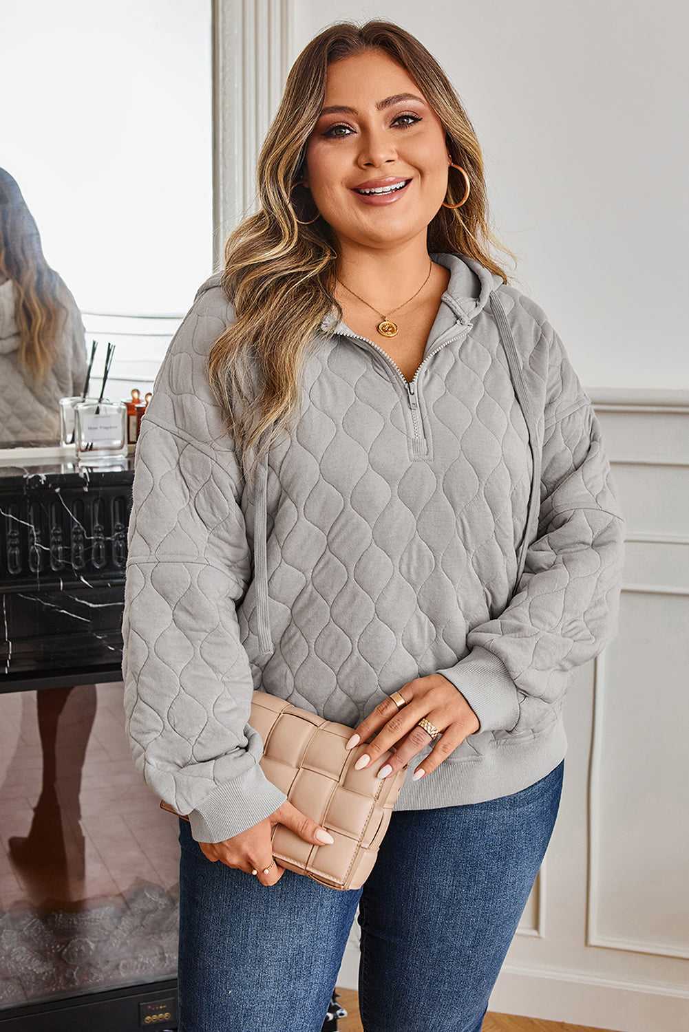 Curve grey quilted quarter-zip hoodie for women styled with jeans, featuring a relaxed fit and cosy texture for casual winter wear.