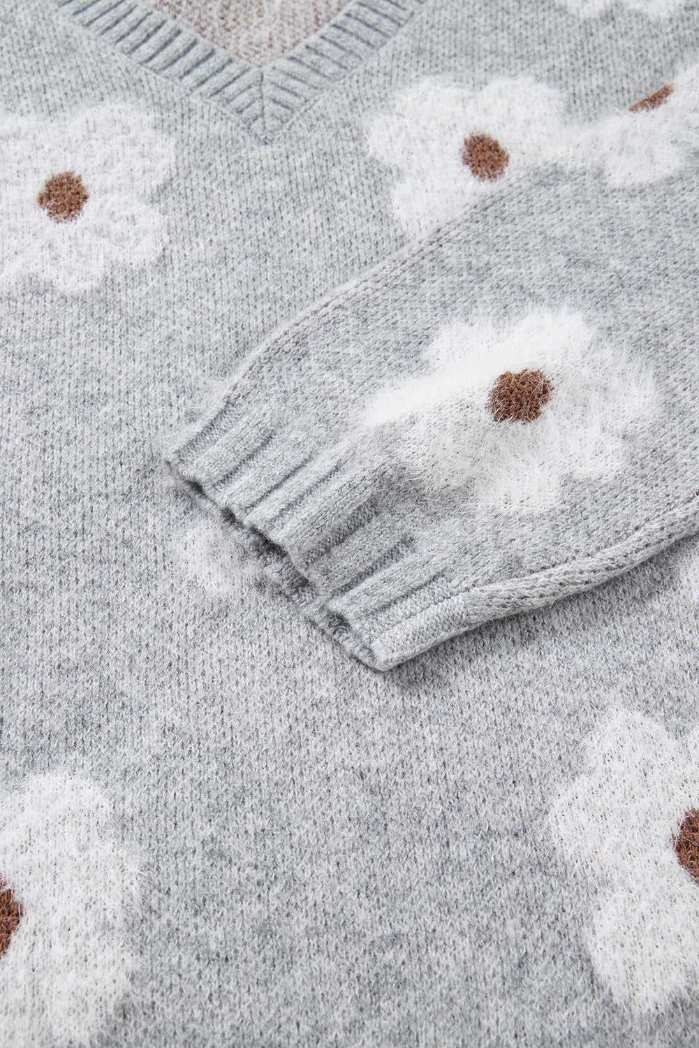 Sleeve and torso detail of FashionFitz Oversized Grey Floral Knit Jumper with ribbed cuff and soft floral knit design.