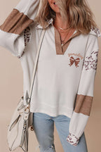 Embroidered Leopard Polo – Chic White Long Sleeve Top with leopard print accents, brown color-block sleeves, and 'gameday' bow detail embroidery.