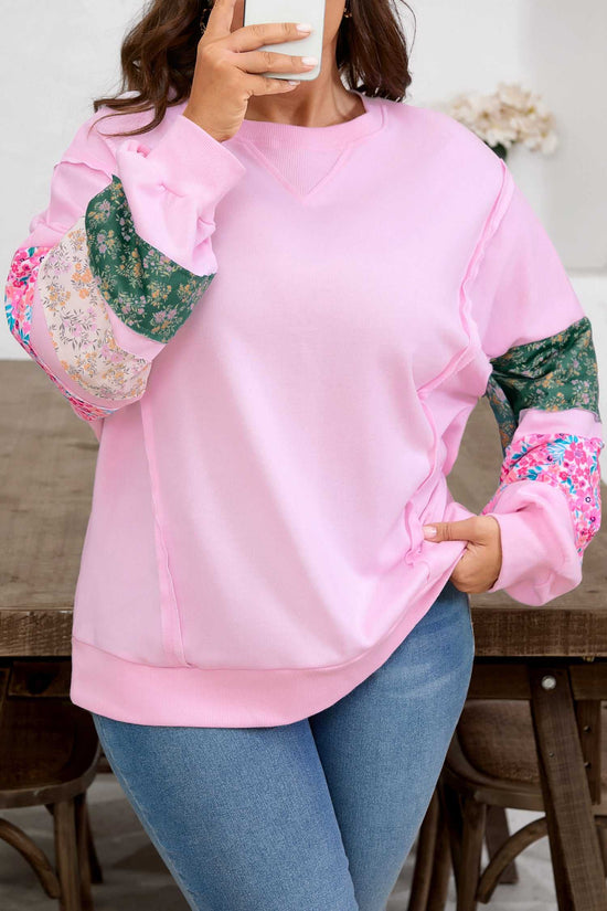 Close-up of Curve Pink Floral Sleeve Baggy Sweatshirt for Women highlighting floral patchwork sleeves and soft pink fabric in a mirror selfie.