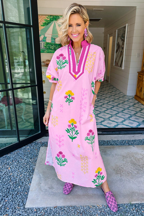 Women's pink floral midi dress lifestyle shot summer garden