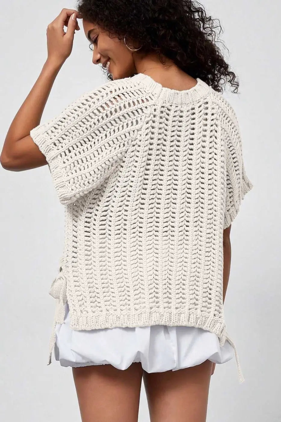Back view of cream Plus Size Bow Tie Open‑Knit Jumper for Women showing relaxed fit and open-knit pattern.