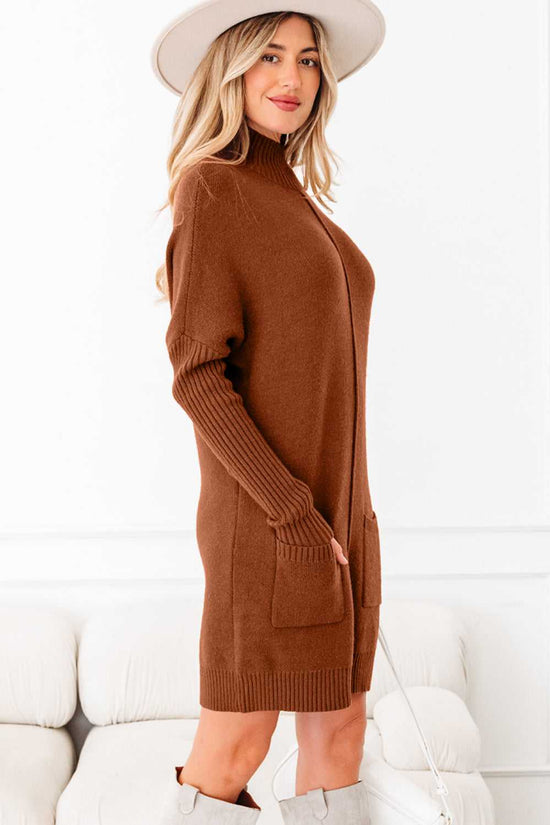 Side view of brown high neck knit jumper dress with long ribbed sleeves and patch pockets. Soft knit sweater dress for winter fashion.