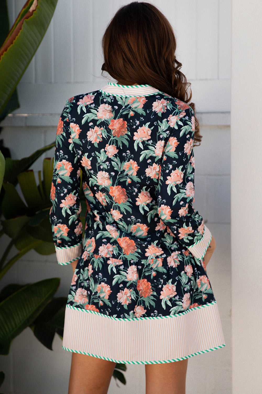 Back view of the Ladies Blue Floral Shift Mini Dress with striped hem and cuffs, showcasing all-over floral print and feminine Southern Belle style.