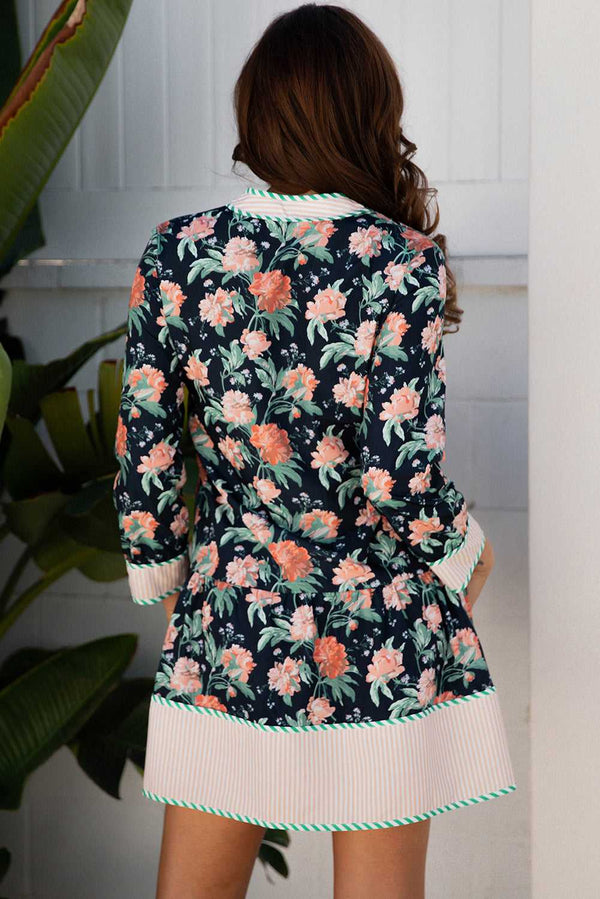 Back view of the Ladies Blue Floral Shift Mini Dress with striped hem and cuffs, showcasing all-over floral print and feminine Southern Belle style.