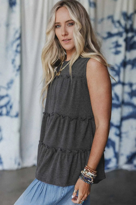 Side profile of dark grey tiered frill tank top for women showing sleeveless cut and layered frill design.