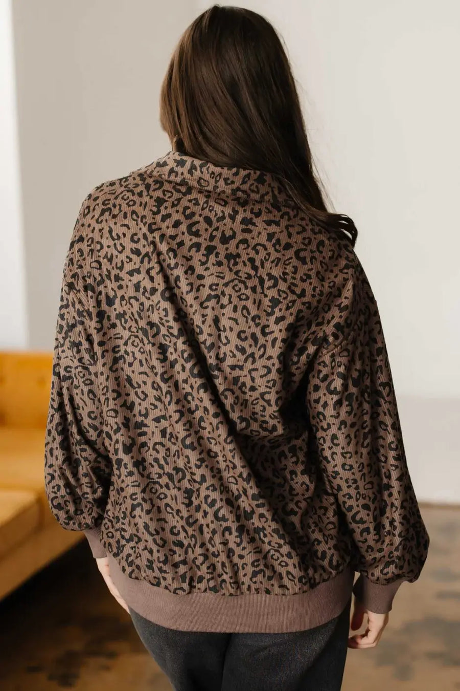 Back view of the Women's Brown Leopard Print Corduroy Half-Zip Jumper showing relaxed fit and ribbed hem design.