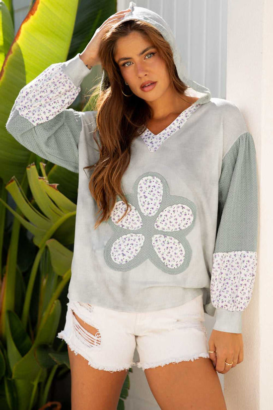 Floral Applique Oversize Hoodie in pear-green waffle knit with V-neck, hood, and floral patchwork design, styled for fall fashion wear.