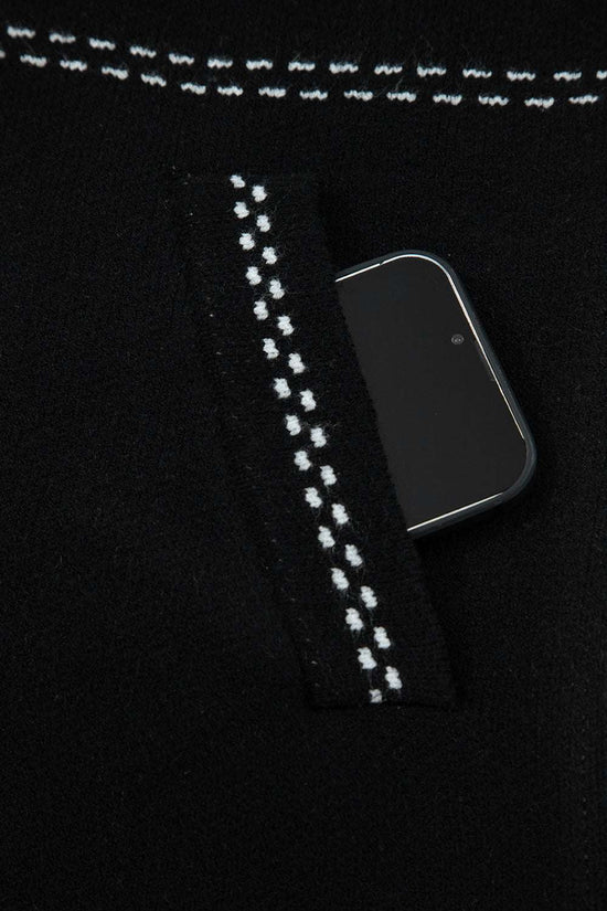Pocket detail of Women's Black Contrast Trim Knitted Cardigan with phone inside, showcasing functionality and stitched trim.
