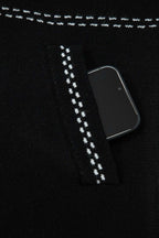 Pocket detail of Women's Black Contrast Trim Knitted Cardigan with phone inside, showcasing functionality and stitched trim.