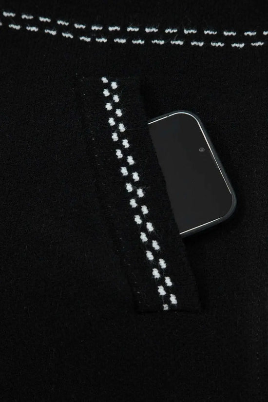 Pocket detail of Women's Black Contrast Trim Knitted Cardigan with phone inside, showcasing functionality and stitched trim.