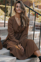 Model sitting in Brown Long Sleeve Tiered Maxi Dress with V-neck and gathered sleeves, ideal for daily autumn wear.