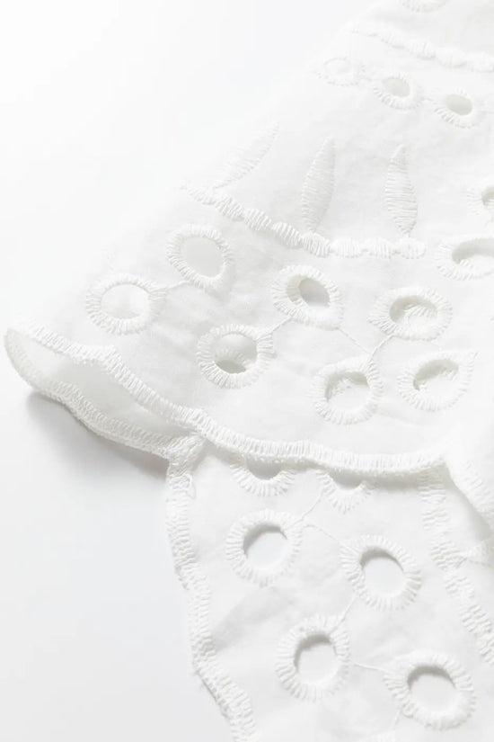 Scalloped hem detail of White Cutwork Embroidered Crop Top, featuring delicate embroidery and breathable cotton fabric.