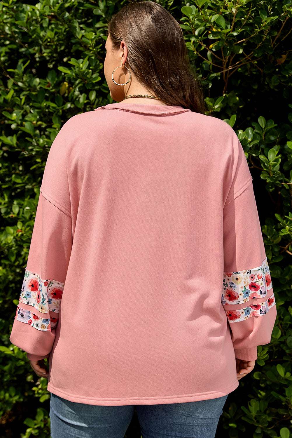 Back view of Curve Blush Peach Floral Appliqué Sweatshirt for Women showing relaxed fit and floral sleeve detail, ideal for plus size casual wear.