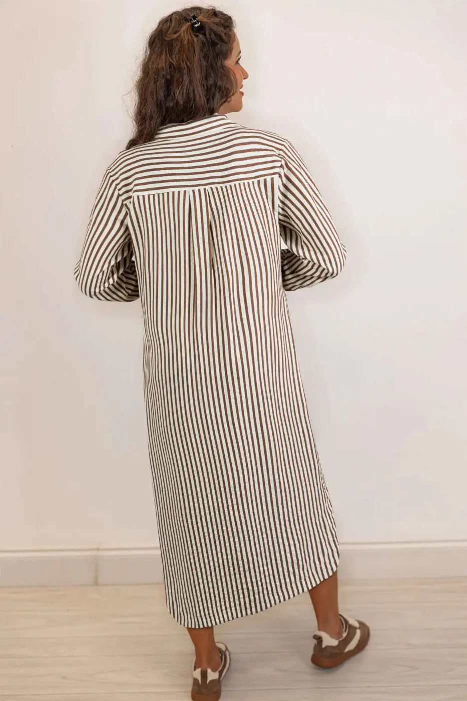 Back view of brown striped midi shirt dress showing H-line silhouette and lightweight fabric, perfect for spring outfits.
