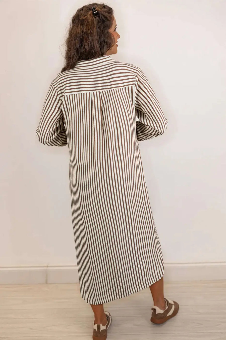 Back view of brown striped midi shirt dress showing H-line silhouette and lightweight fabric, perfect for spring outfits.