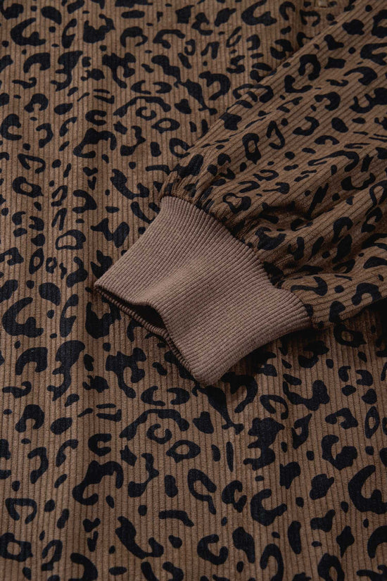 Sleeve and cuff detail of brown leopard print corduroy half-zip jumper. Ribbed cuff adds comfort and style to this fall essential.