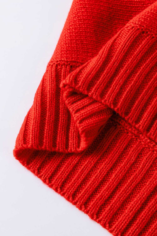 Hem and ribbed knit detail of red high neck Christmas sweater, made from soft acrylic for cozy seasonal wear.