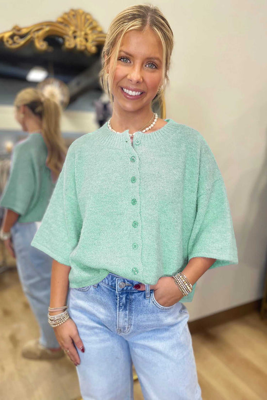 Fuzzy knit cardigan women in pastel jade with button-down front and 3/4 sleeves, styled casually with denim.