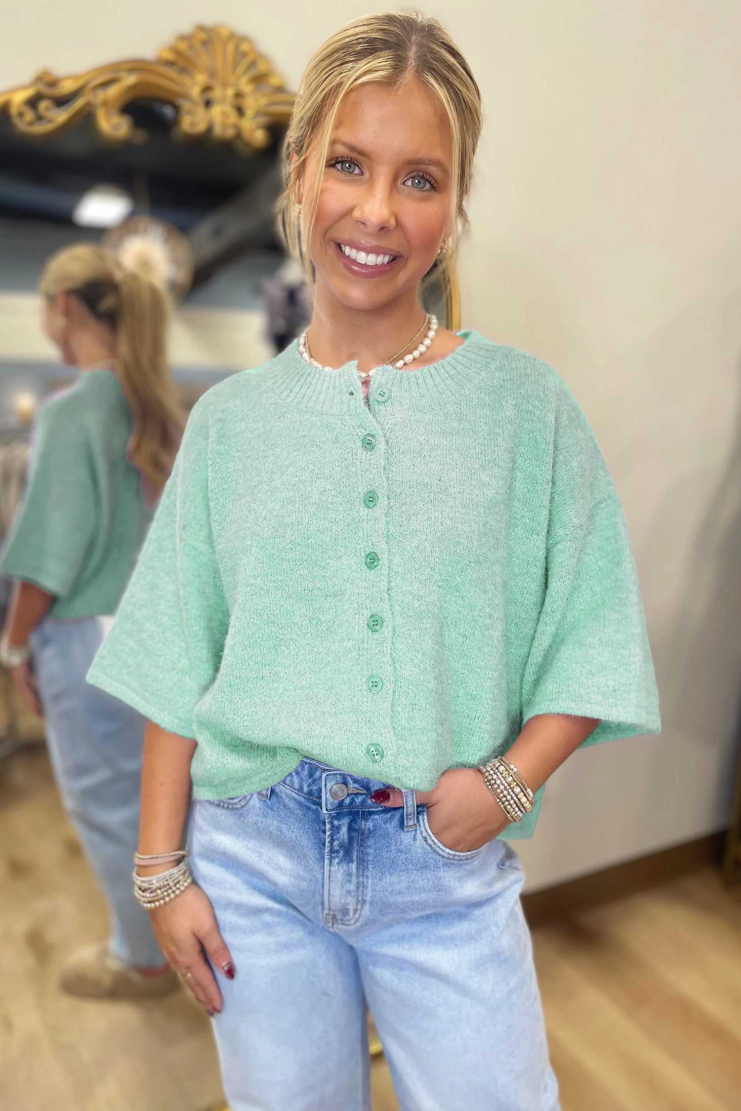 Fuzzy knit cardigan women in pastel jade with button-down front and 3/4 sleeves, styled casually with denim.