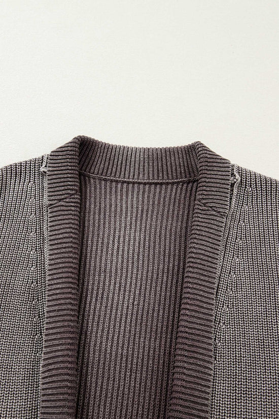 Close-up of neckline and ribbed detailing on brown stonewash patchwork knit open cardigan, highlighting its textured knit craftsmanship.