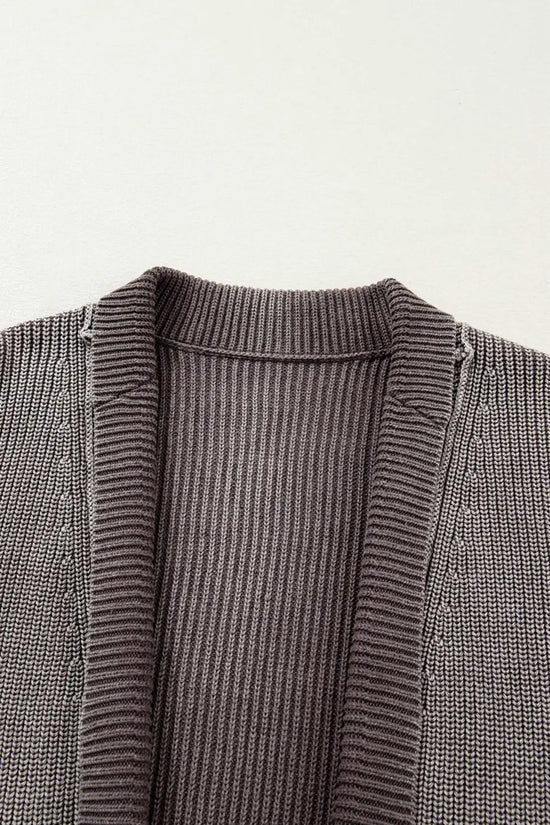 Close-up of neckline and ribbed texture on women's stonewash patchwork knit open cardigan, highlighting soft knit details.