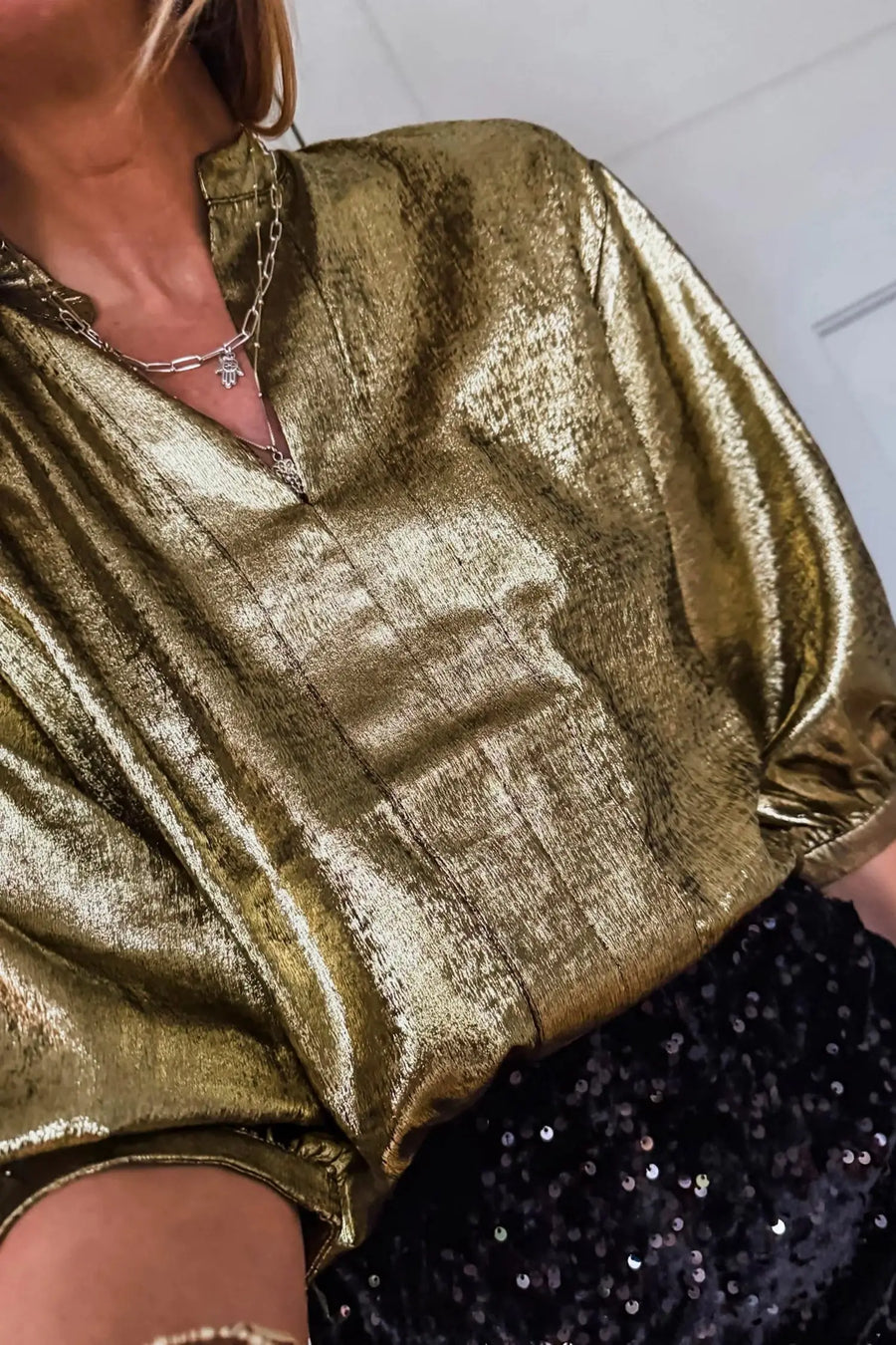 Flat lay of gold metallic split neck blouse showing half sleeves and fabric detail Fashionfitz UK