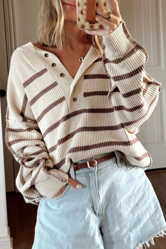 Casual slouchy striped Henley jumper in cream and brown, styled with light denim shorts for a relaxed fall look.