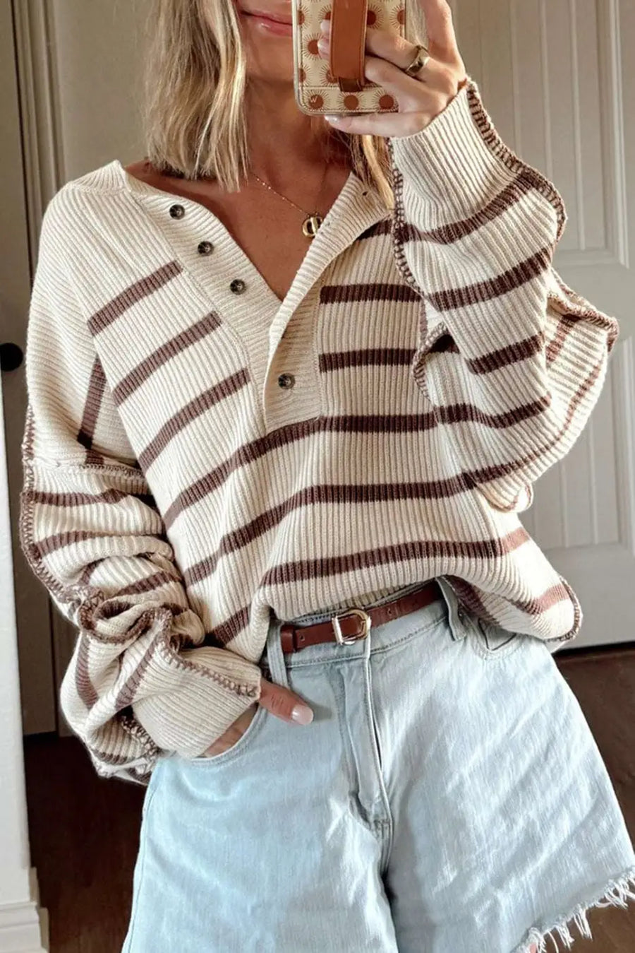 Casual slouchy striped Henley jumper in cream and brown, styled with light denim shorts for a relaxed fall look.
