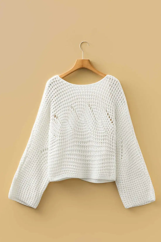 White wide sleeve hollow knit jumper displayed on hanger against beige background, showcasing its loose fit and open-knit detail.