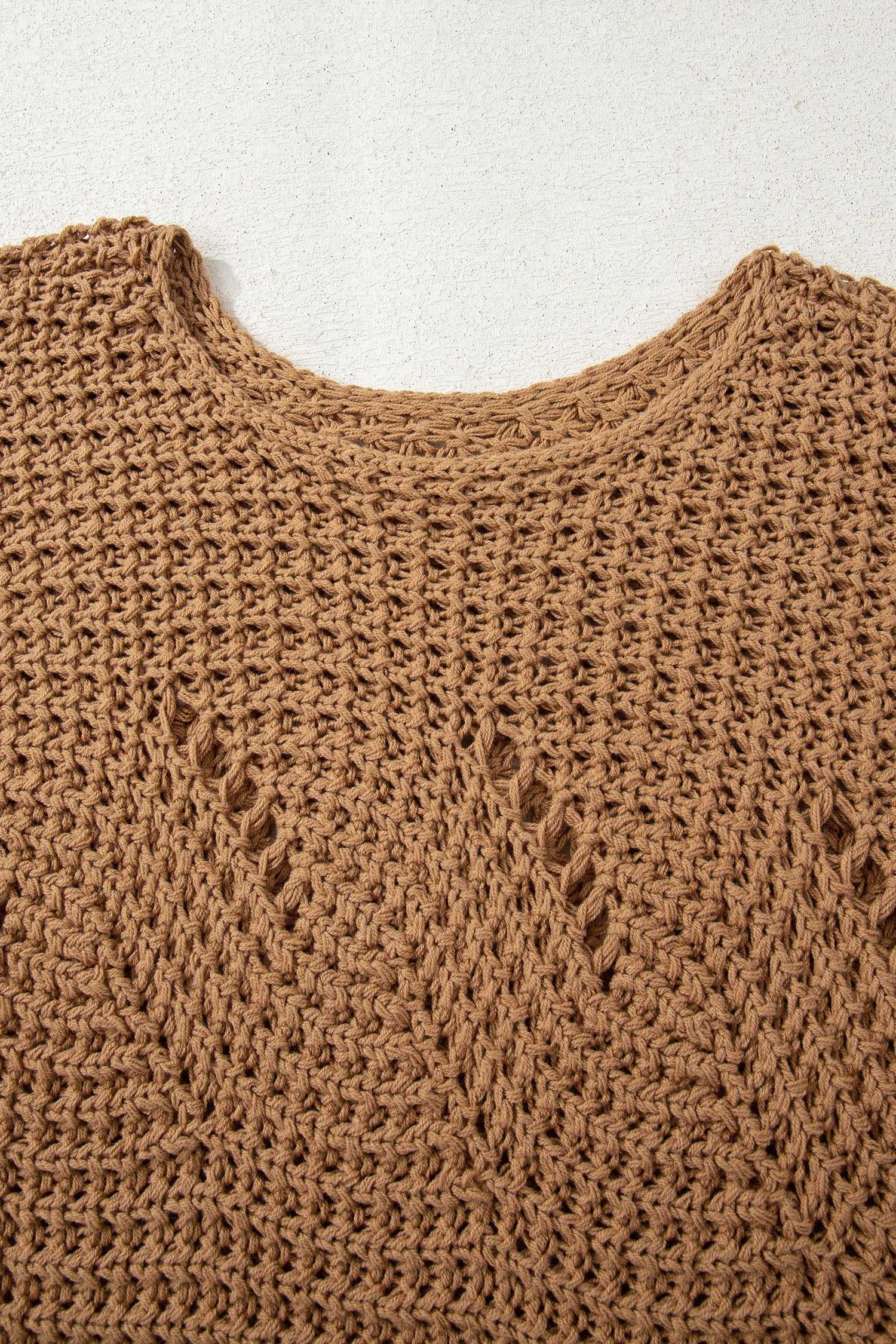 Close-up of brown hollow knit jumper neckline and pattern, showcasing the textured open-knit design for breathable wear.