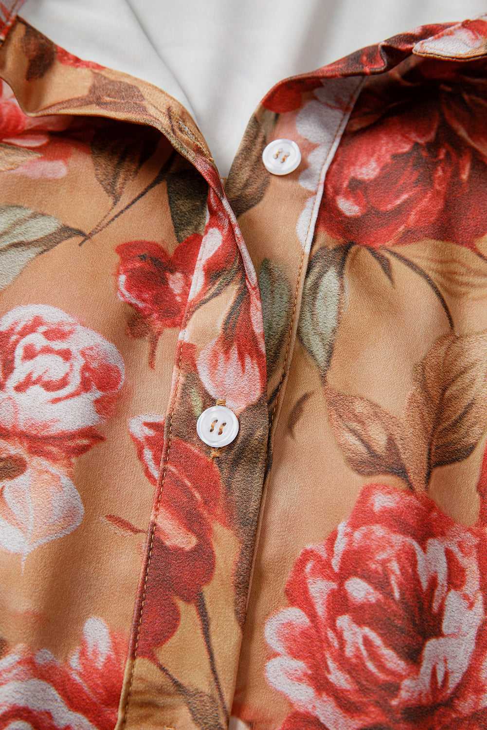 Close-up of Retro Floral Ruffle Mini Dress button placket, highlighting soft fabric and detailed floral print in warm tones.