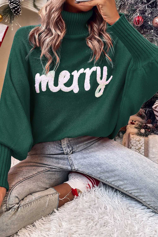 Green version of the Stylish High Neck Red Sweater - Christmas, worn with jeans in a festive setting, featuring bold 'merry' embroidery.