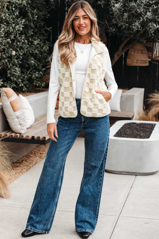 Woman wearing a Sherpa Fleece Vest, white shirt, and blue jeans outdoors.
