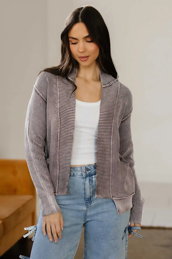 Women's stonewash patchwork knit open cardigan in brown with ribbed texture, styled casually over a white tank top and light denim jeans.