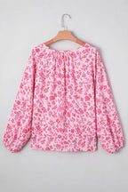 Front view of Pink Floral Lightweight Blouse on hanger, featuring v-neckline and long sleeves with floral print.