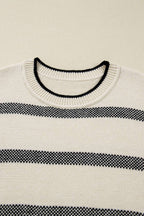 Close-up of neckline on Women's Apricot Striped Bell Sleeve Jumper, featuring ribbed collar with black trim. Highlights quality knitwear details.