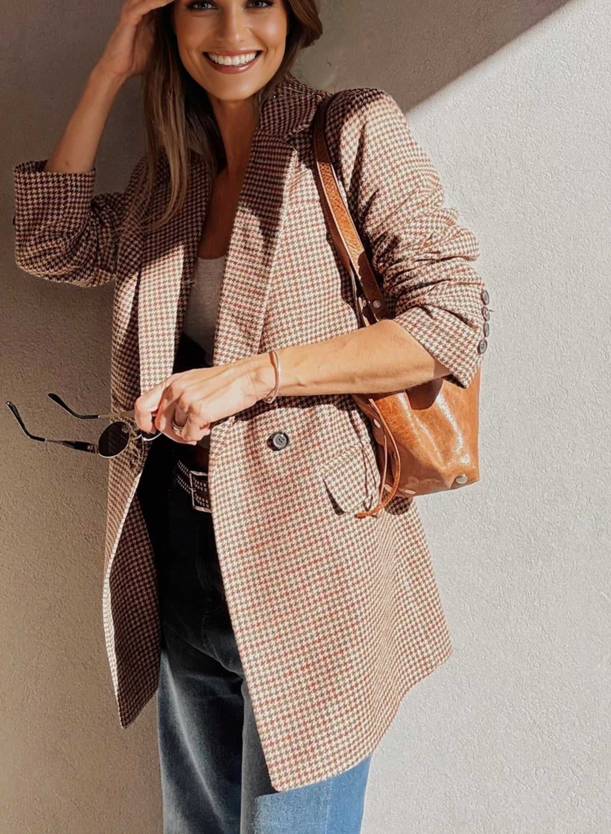 Ladies Brown Houndstooth Fitted Blazer worn open over a white tank top and jeans, perfect for casual autumn outings.