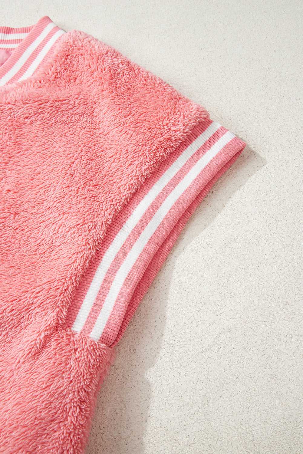 Collar and shoulder seam detail on pink sherpa vest