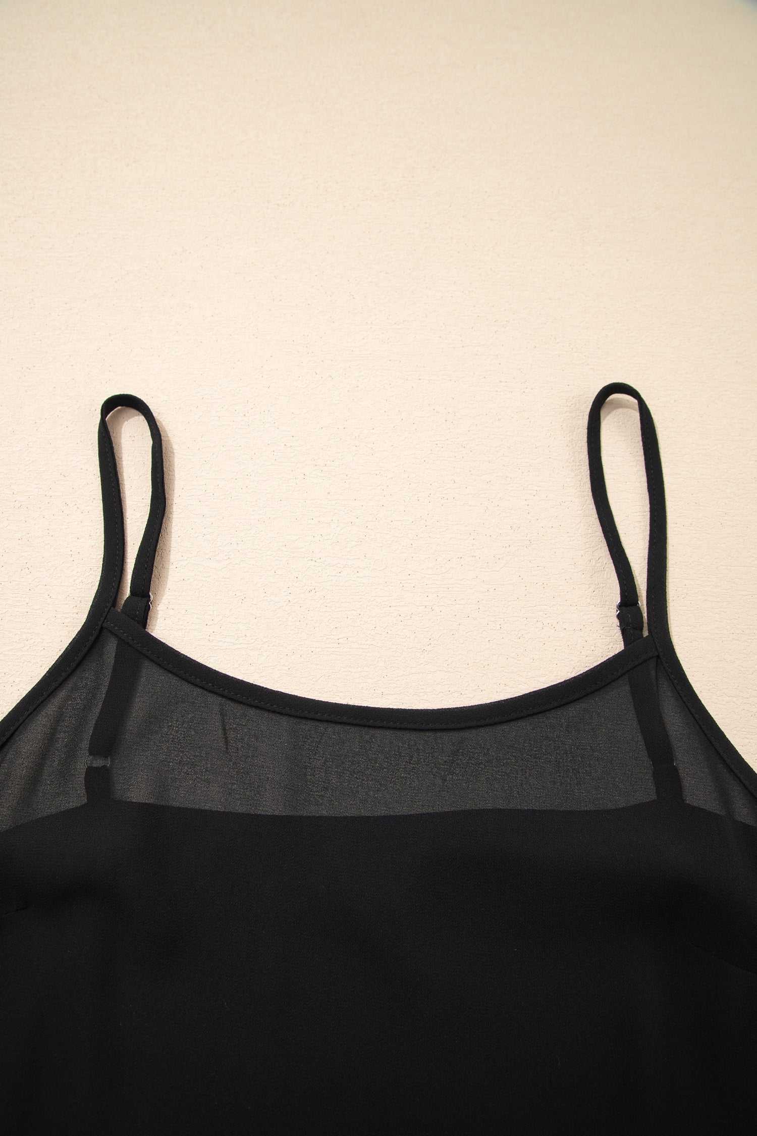 Close-up of neckline on Black Floral Sleeveless Maxi Dress with sheer panel and thin straps for a feminine summer look.