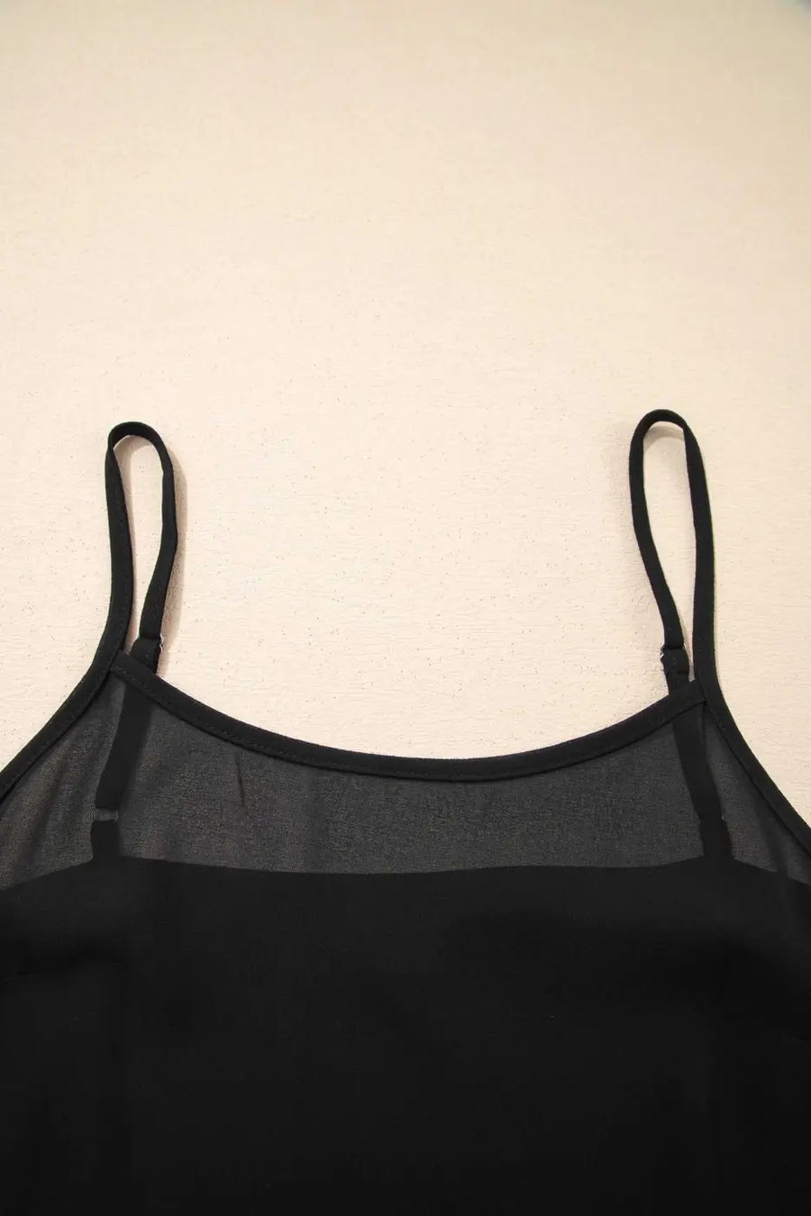 Close-up of neckline on Black Floral Sleeveless Maxi Dress with sheer panel and thin straps for a feminine summer look.