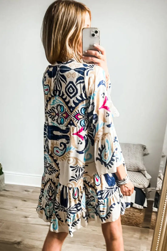 Back view of the Boho Tribal Mini Dress with bracelet sleeves and tiered A-line silhouette, showcasing vibrant ethnic patterns.