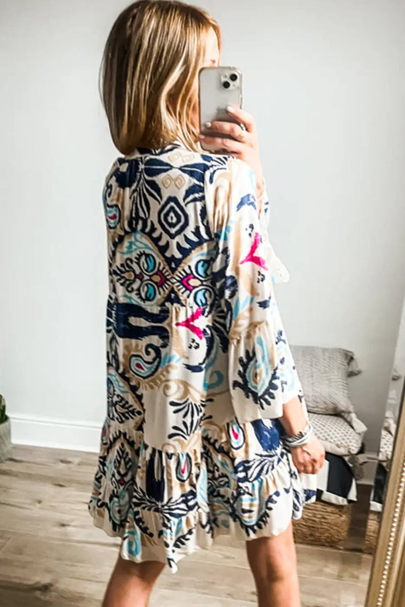 Back view of the Boho Tribal Mini Dress with bracelet sleeves and tiered A-line silhouette, showcasing vibrant ethnic patterns.