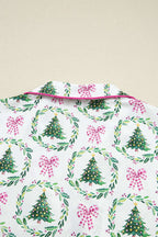 Close-up of collar on White Christmas Print Velvet Trim Pyjamas showing pink piping and holiday-themed tree and bow print.