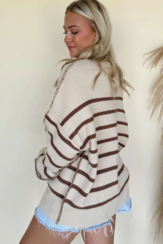 Back view of casual slouchy striped Henley jumper in beige and brown. Lightweight women’s knit sweater ideal for autumn daily wear.