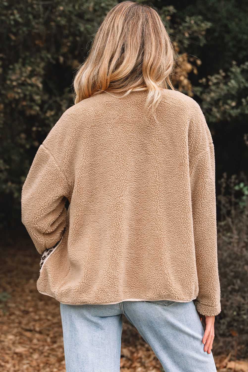 Back view of women’s plush fleece jacket in camel color, showcasing soft sherpa texture and relaxed fit for casual outerwear styling.