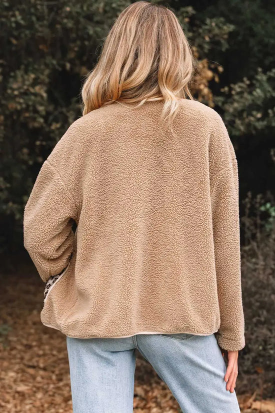 Back view of women’s plush fleece jacket in camel color, showcasing soft sherpa texture and relaxed fit for casual outerwear styling.