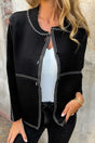 Women's Black Contrast Trim Knitted Cardigan styled with white top and black jeans, featuring front buttons and bold white stitching.